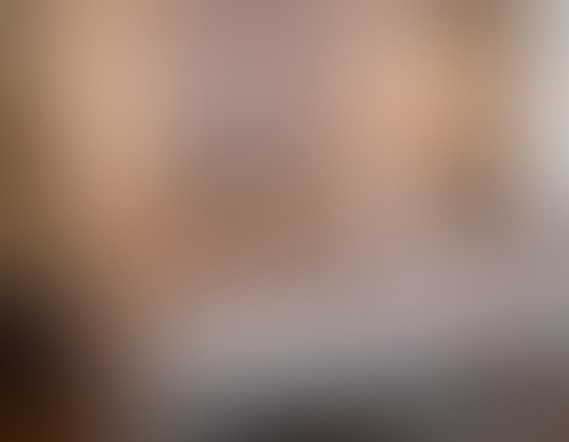 A beautifully arranged scene showcasing an elegant lingerie collection, featuring luxurious fabrics such as silk and lace in soft pastel colors. Include a cozy, inviting setting with plush pillows and delicate candlelight to evoke warmth and comfort. Display a mix of high-fashion couture styles and cozy loungewear, alongside floral accents for a feminine touch. Capture a sense of intimacy and celebration. soft focus, romantic lighting, super-realistic.